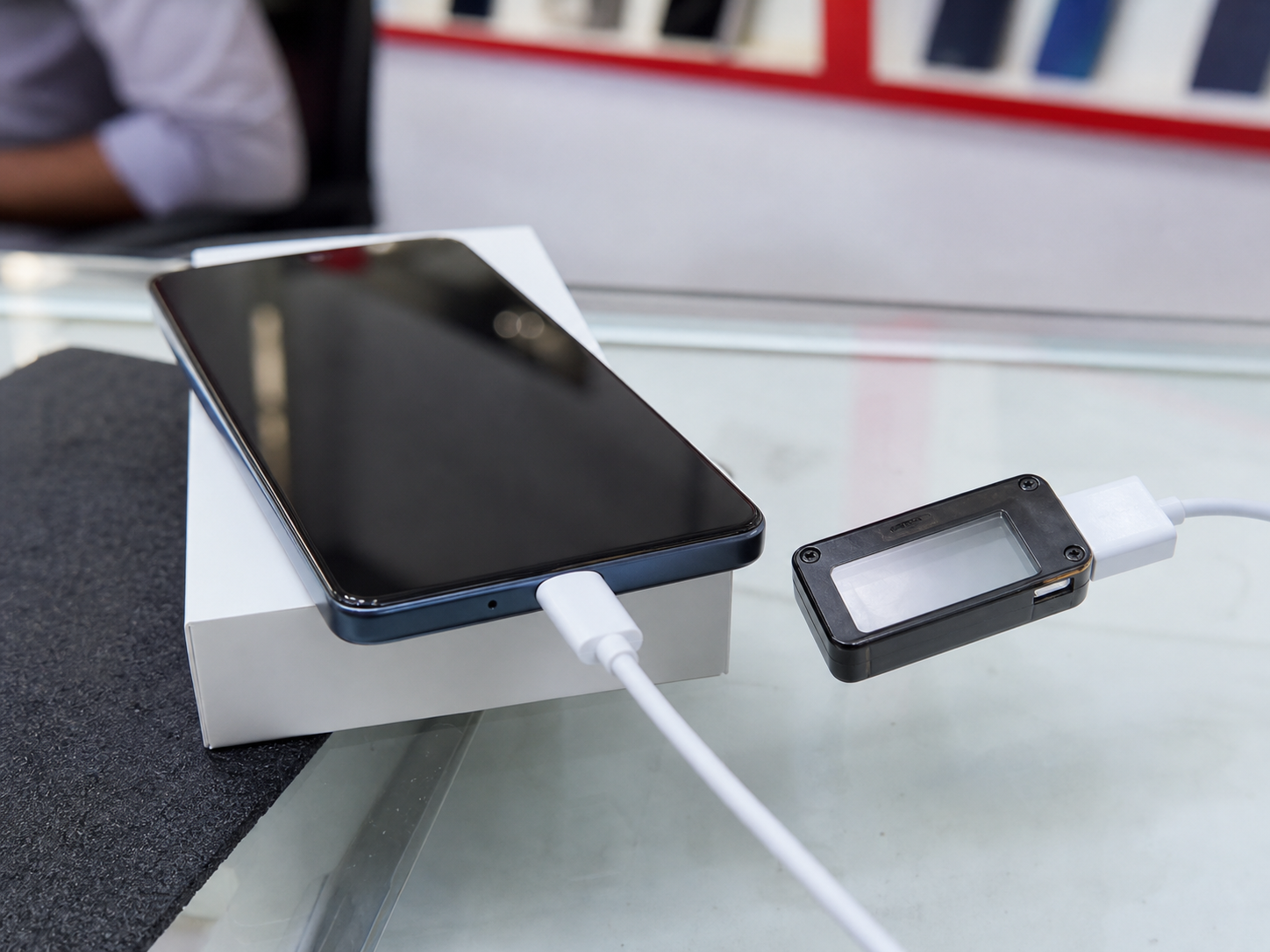 Smartphone battery and charging check on a mobile shop counter